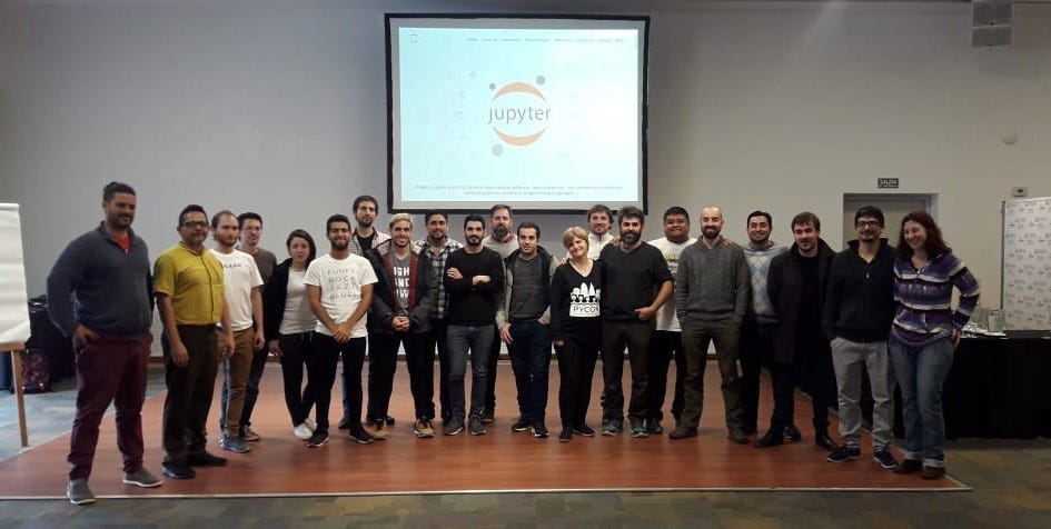 Top Image: Jupyter for Scientific User Facilities and High-Performance Computing, (Photo Credit, Fernando Perez). Bottom Left Image: Intro to Python for Kids, Parents & Teachers Workshop Series. Bottom Middle Image: Dashboarding in the Jupyter Ecosystem Workshop (Photo Credit, Lindsey Heagy) Bottom Right Image: South America Jupyter Community Workshop